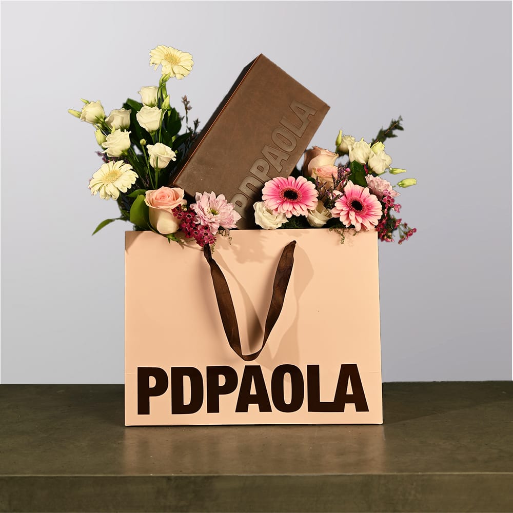 A box of flowers with jewelry box in it.