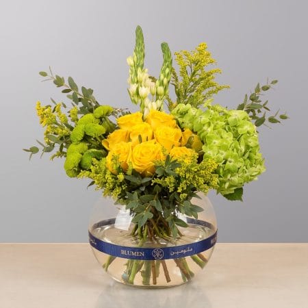 An elegant floral arrangement featuring premium blooms, delicate seasonal flowers, and fresh greenery, beautifully arranged in a modern decorative vase.