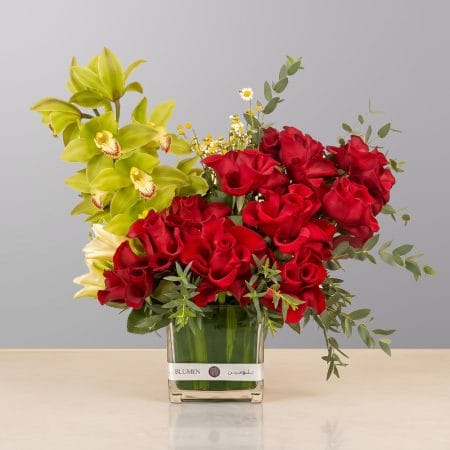 A luxurious floral arrangement featuring premium blooms, delicate seasonal flowers, and fresh greenery, elegantly arranged in a decorative vase.